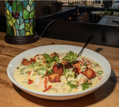 High Country Shrimp & Grits with crispy pork belly hot from the pan